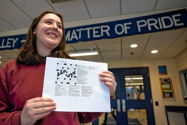 Merrimack Valley High School senior Natalie DeGreenia holds up one of her crossword puzzles she has created for her senior project on Wednesday, April 3, 2024 in the foyer of the school.