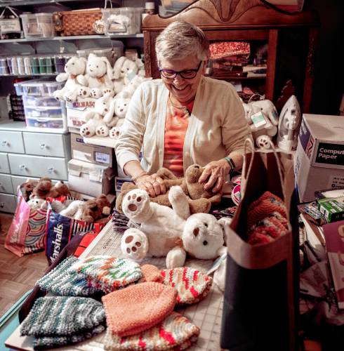 Nancy Peperissa in her sewing room in her Penacook home where she puts the finishing touches on making skull caps for chemotherapy patients and filling teddy bears with rice to comfort Alzheimer patients.