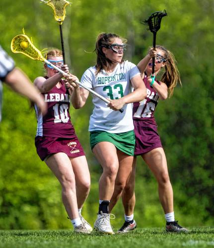 Hopkinton attacker Sydney Westover shoots through two Lebanon defenders during the second quarter on Monday May 20, 2024.
