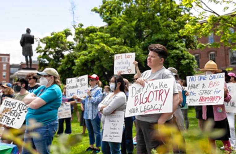 Karen Daniell of Stratham holds a “don’t make bigotry your legacy” sign outside the N.H. Statehouse as people gather Wednesday morning for the Live Free Rally in Concord. The rally urged Gov. Chris Sununu to veto recently passed bills that would curb rights for trans youth and adults across the state. Karen Daniell of Stratham holds a “don’t make bigotry your legacy” sign outside the N.H. Statehouse as people gather Wednesday morning for the Live Free Rally in Concord. The rally urged Gov. Chris Sununu to veto recently passed bills that would curb rights for trans youth and adults across the state.