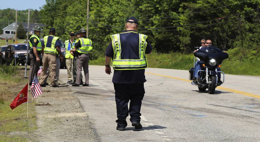 FILE - Members of the National Transportation Safety Board and the New Hampshire State Police investigate the scene of a collision involving a pick-up truck and numerous motorcycles in Randolph, N.H., June 23, 2019. Relatives and friends of seven motorcyclists who died in a 2019 crash urged New Hampshire officials Wednesday, June 19, 2024 during an emotional hearing not to allow the trucker back on the state's roadways. (Peter Knudson/National Transportation Safety Board via AP)