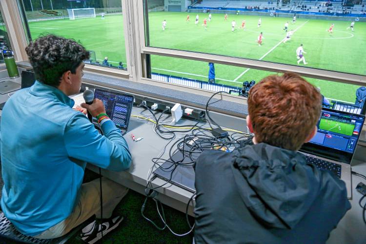 Erik Valdovinos (left) and Evan Coady broadcast the first ever Spanish-language call of the NCAA national soccer championships from the press box at the Sportsplex in Matthews, N.C. 