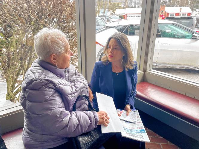 Marianne Williamson speaks Friday with Lucille Ketchum, a Democrat who says she will not write in President Joe Biden’s name on Tuesday’s ballot. 
