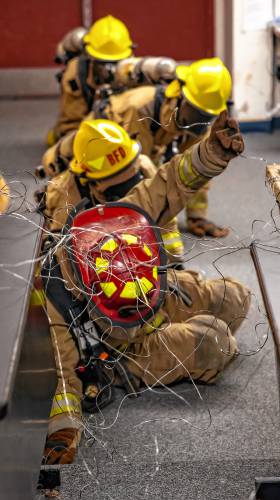 Addison “Nails” Bergeron leads the group through the obstacle course at their CRTC firefighter class at Concord High School on Thursday, March 7, 2024.