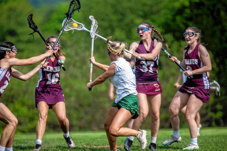 Hopkinton midfielder Sarah Chodosh shoots through four Lebanon defenders to score during the second quarter on Monday May 20, 2024.