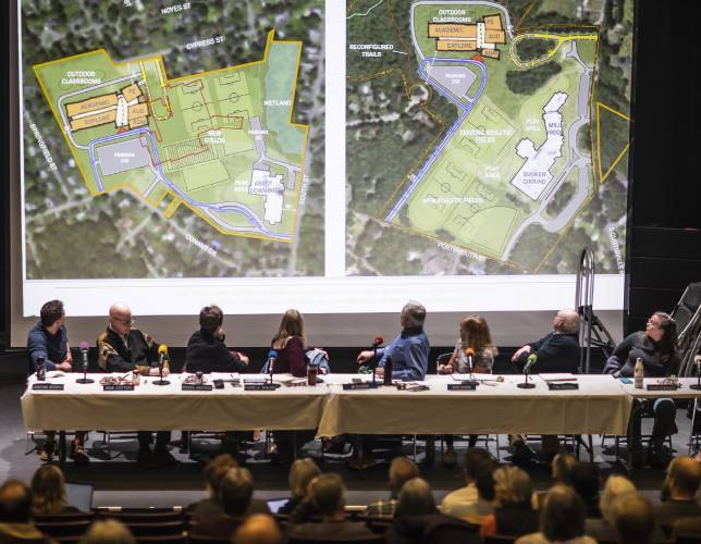The Concord School Board looks up at the two site plans for the Rundlett Middle School at the opening of the meeting on Dec. 6, 2023. The board voted to build the new school on the Broken Ground School site.