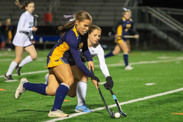Bow’s Peyton Vaughn (blue), dribbles past a Hollis-Brookline defender in the Falcons’ 3-0 loss to Hollis-Brookline in Tuesday’s semifinal.
