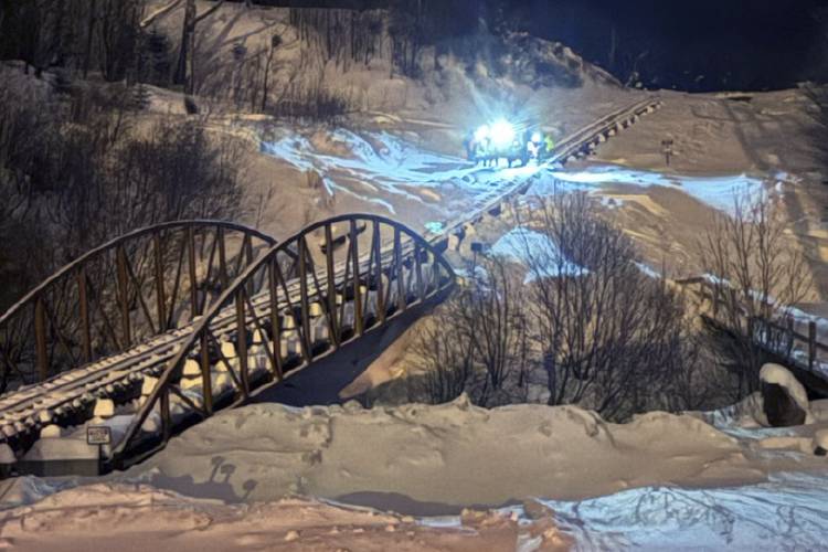 This image provided by the New Hampshire Fish and Game Department shows rescue hikers along the cog railway during a rescue mission, on Mount Washington, N.H., Sunday, Feb. 2, 2025. (New Hampshire Fish and Game Department photo via AP)