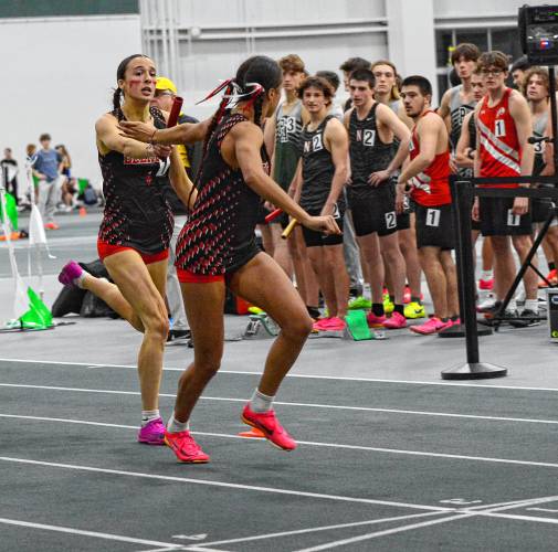 Belmont’s Adeline Takantjas hands off the baton to Ava Lacasse for the final exchange during the 4x400 relay at the NHIAA Division II indoor track and field championship on Saturday at Plymouth State University. Belmont finished second in the 4x400 and won the title in the 4x200, helping lead the Raiders to third place overall.