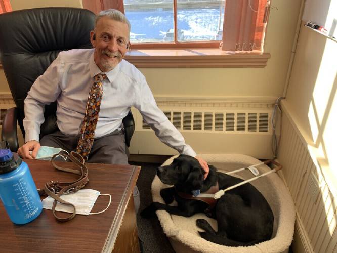 President and CEO of Future In Sight Randy Pierce with his guide dog, Swirl.