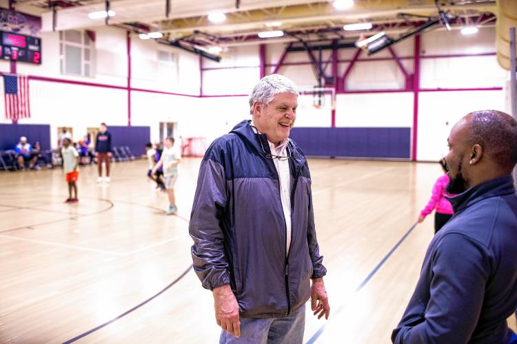 Bob Wolfe talks with Pascal Zabayo during a youth basketball game for New American kids at Abbot Downing School on Thursday night, February 22, 2024. Wolfe has known Pascal since he was 15 and now Zabayo helps mentor New Americans.