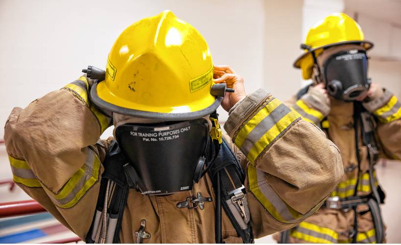 CRTC firefighter students put on their darkened masks to simulate smoky situations before working through an obstacle course on Thursday, March 7, 2024 at Concord High School.