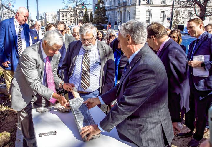 Sen. Jeb Bradley and House Speaker Sherman Packard inspect the time capsule as they open it at the former DOJ and Mechanics Bank building on North State Street on Tuesday.