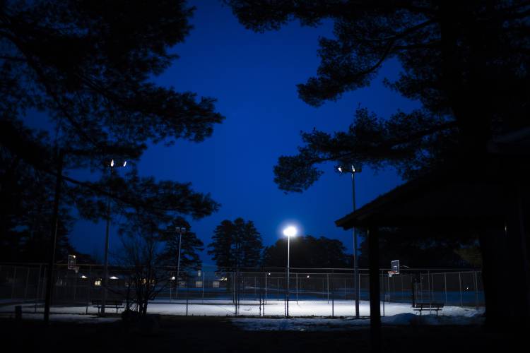 Lights illuminate the basketball court at Keach Park at dusk on Tuesday evening, March 22, 2023. Lights illuminate the basketball court at Keach Park at dusk on Tuesday evening, March 22, 2023.