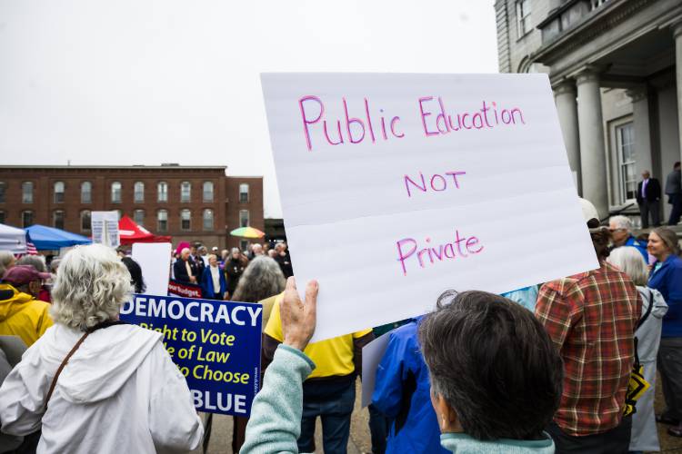 Homemade signs abound at the Fight for Our Future rally at the State House before the budget hearing inside the Representatives Hall on Tuesday, May 6, 2025.